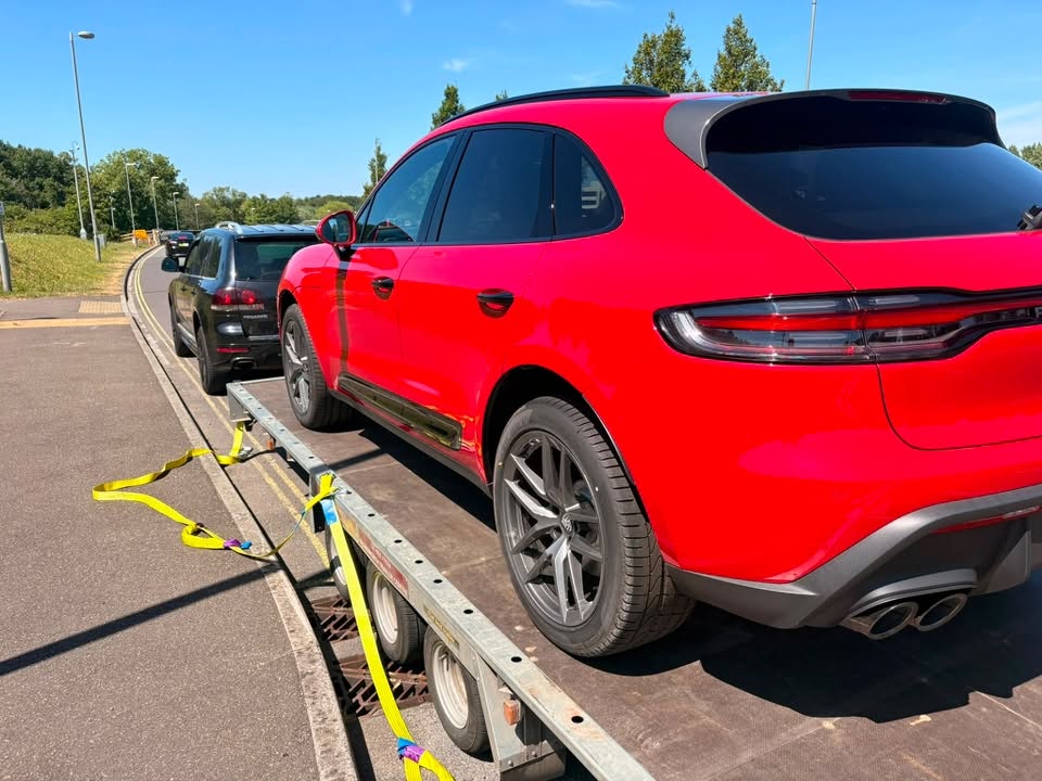 Red Porsche Macan secured on the transporter